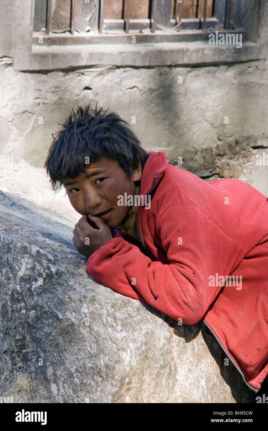 tibetan boy in the streets of the border town of zhangmu or dram Stock Photo