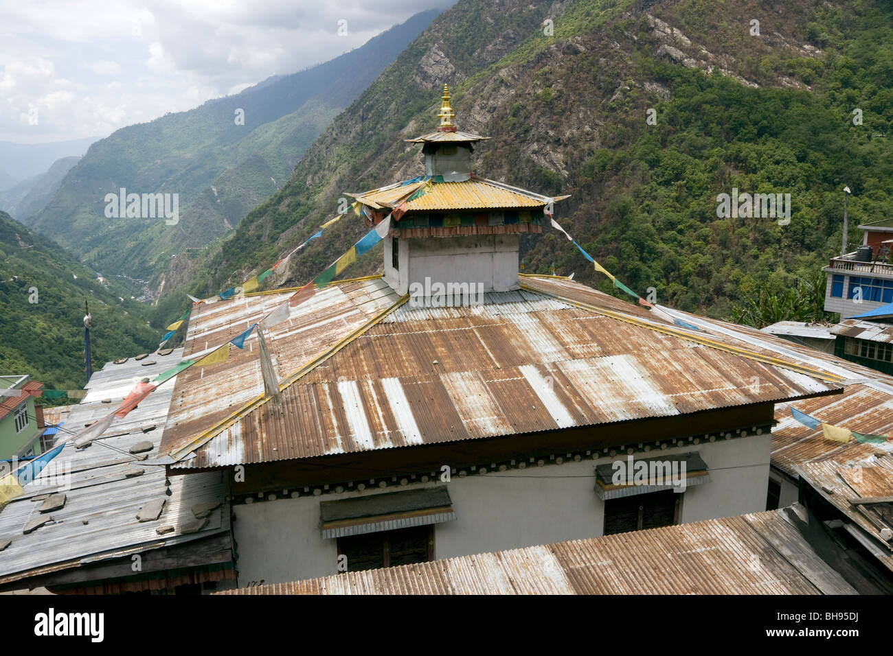 view of the roof of temple in zhangmu tibetan border town looking down the valley towards nepal Stock Photo