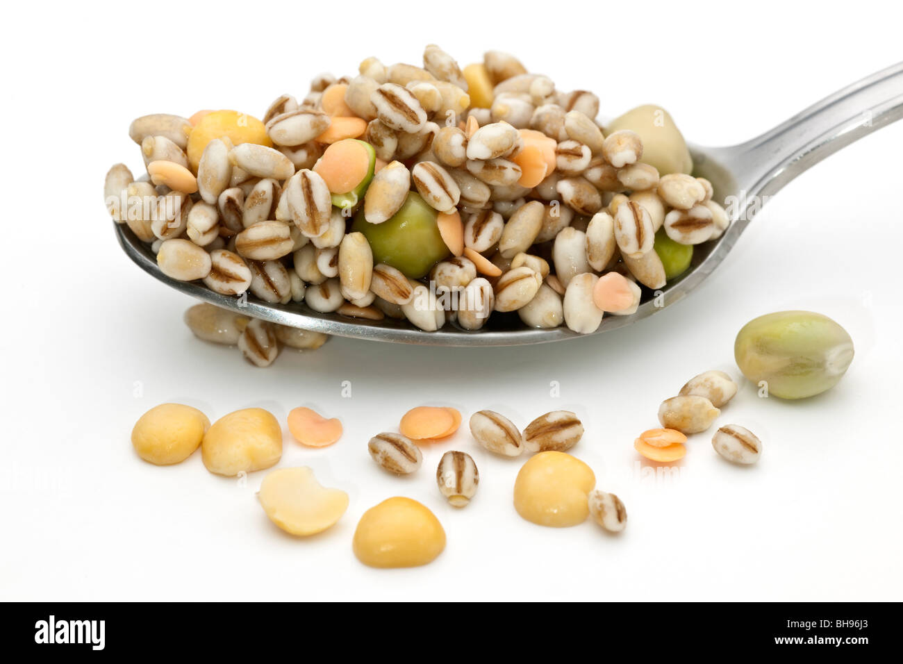 Spoonful of soaked mixed dried peas and lentils Stock Photo