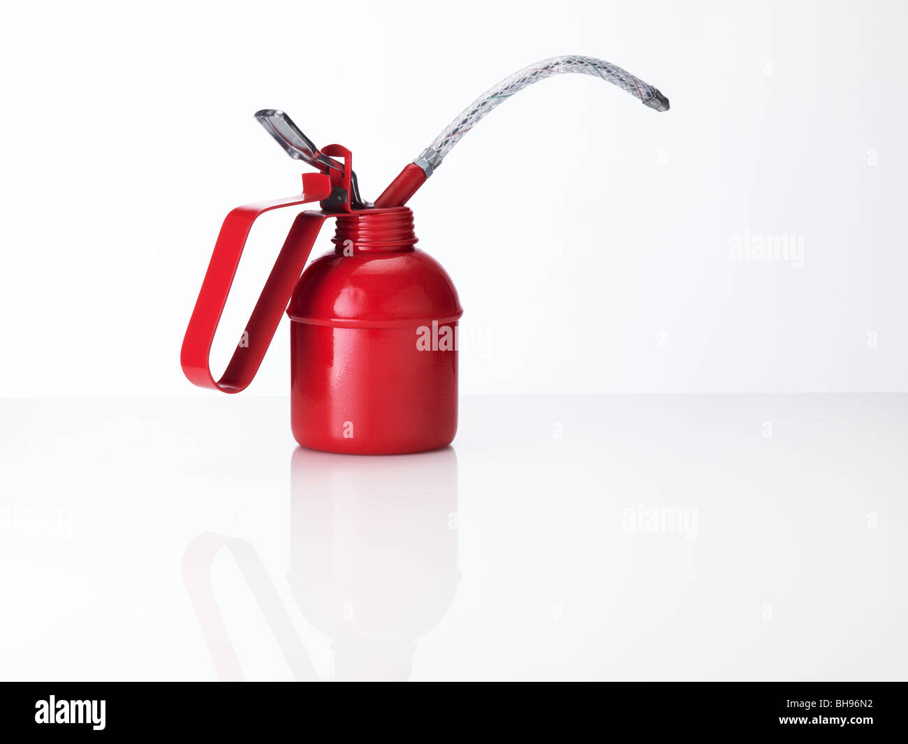 Traditional red oil can on a white background Stock Photo - Alamy