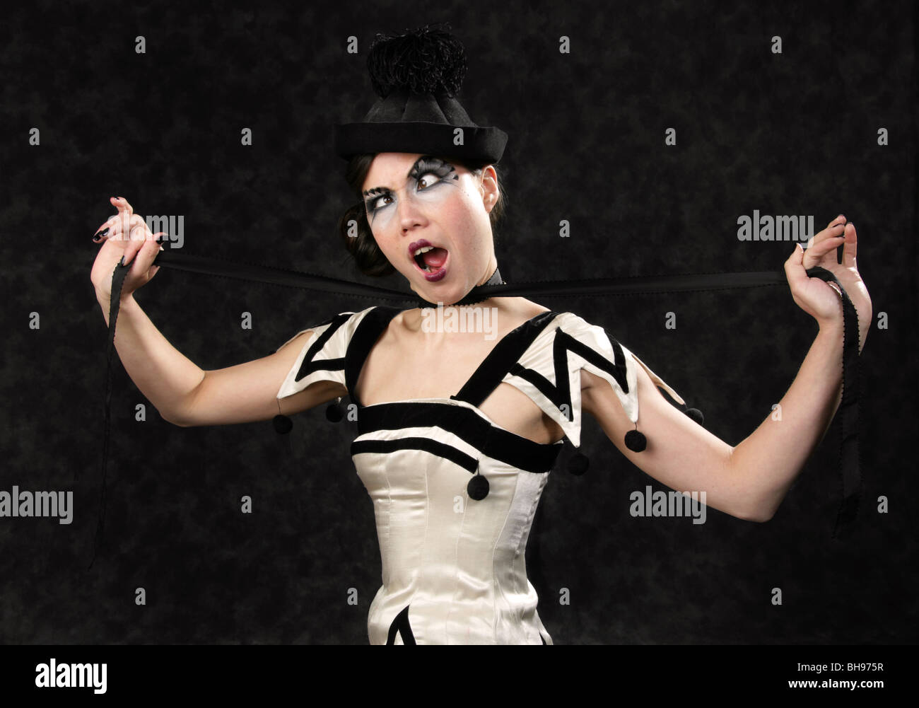 Comedy Burlesque Performer Pretending to Strangle Herself and Making a Funny Face Stock Photo
