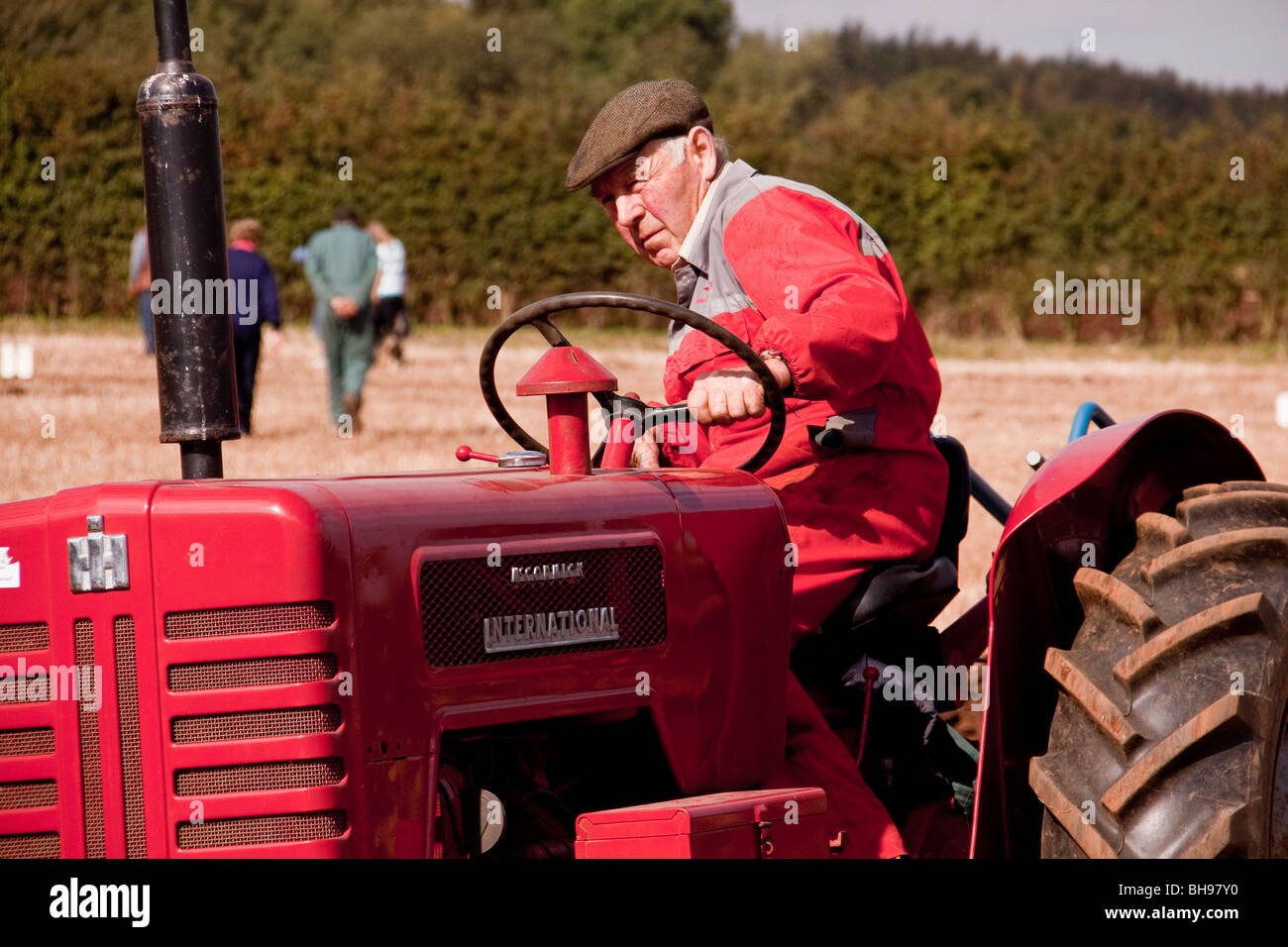 Man ploughing on tractor in paddock Stock Photo