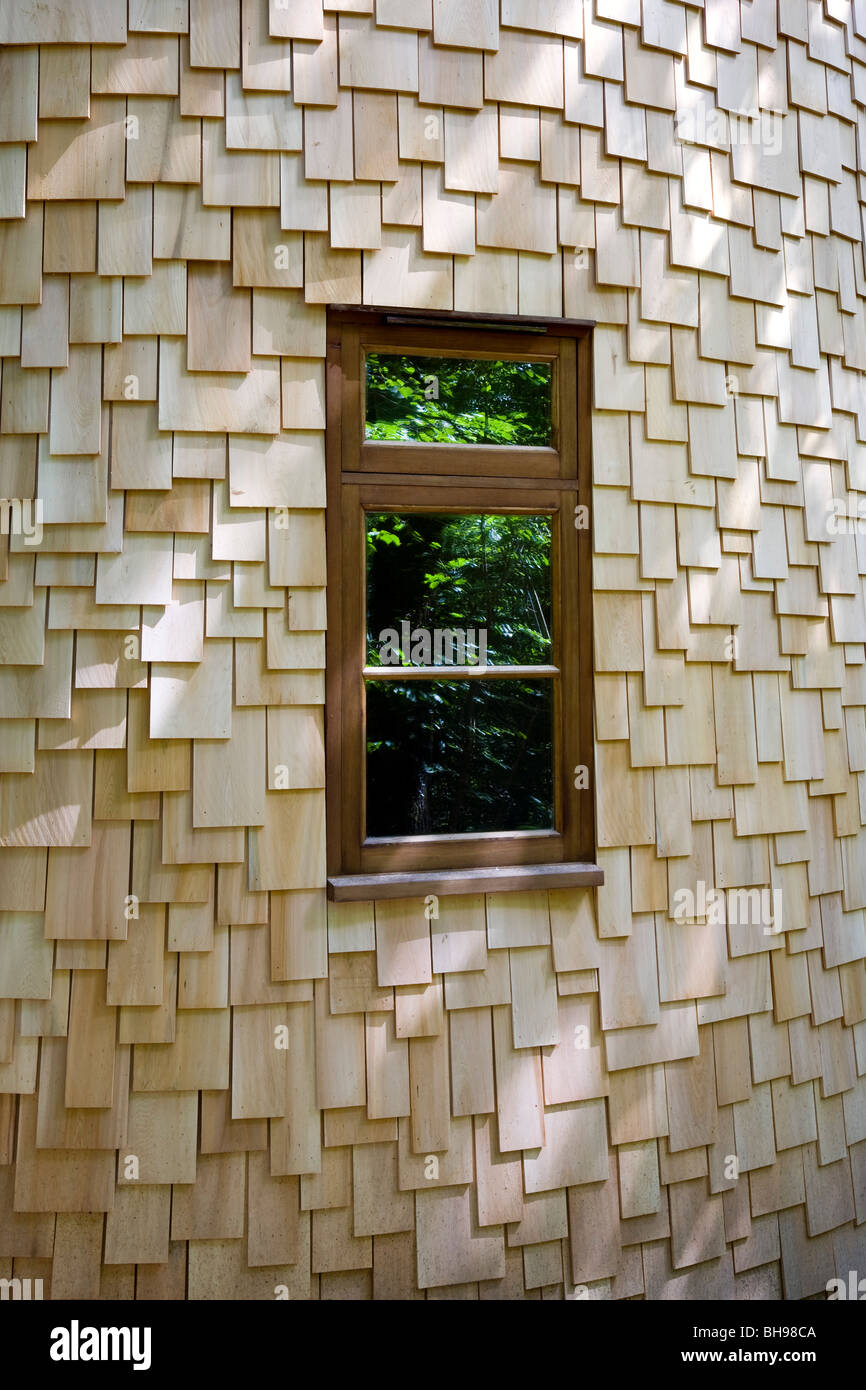 Softwood shingles surrounding hardwood timber window frame Stock Photo