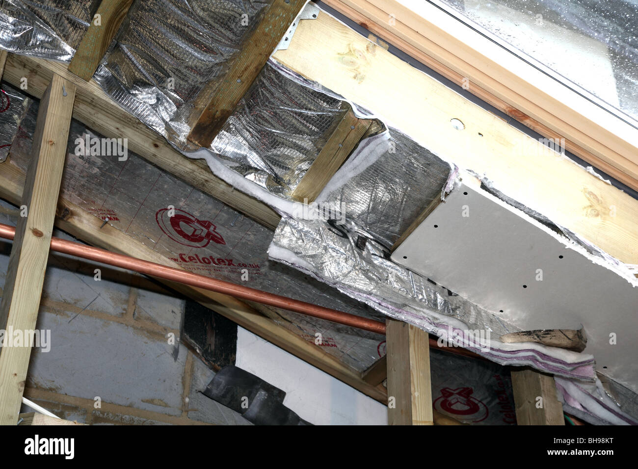 Installation Of Foil Roof Insulation In A Domestic Property Stock