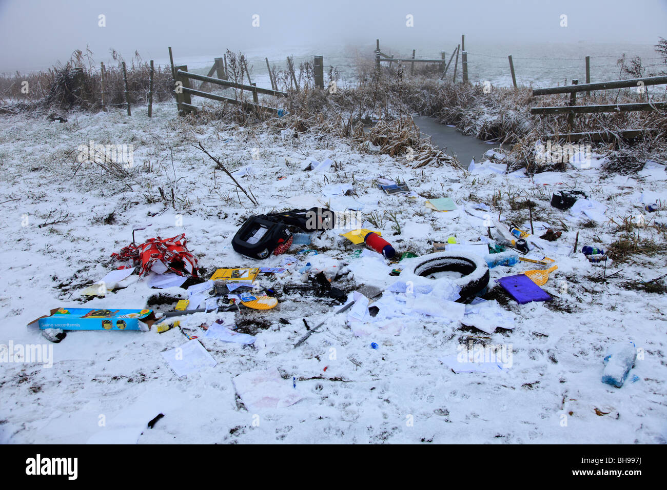 A Selection of rubbish strewn over a winter fenland field Stock Photo
