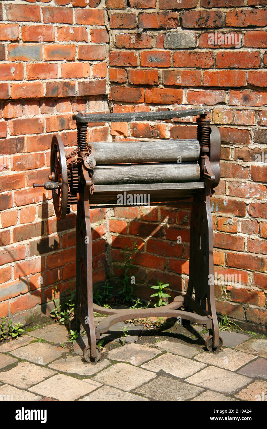 Old clothes wringer (mangle) in a back yard setting Stock Photo - Alamy