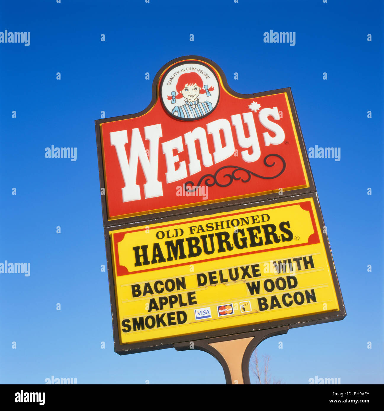 Wendy's Hamburgers fast food restaurant sign against blue sky copy space in Ontario Canada North America  KATHY DEWITT Stock Photo