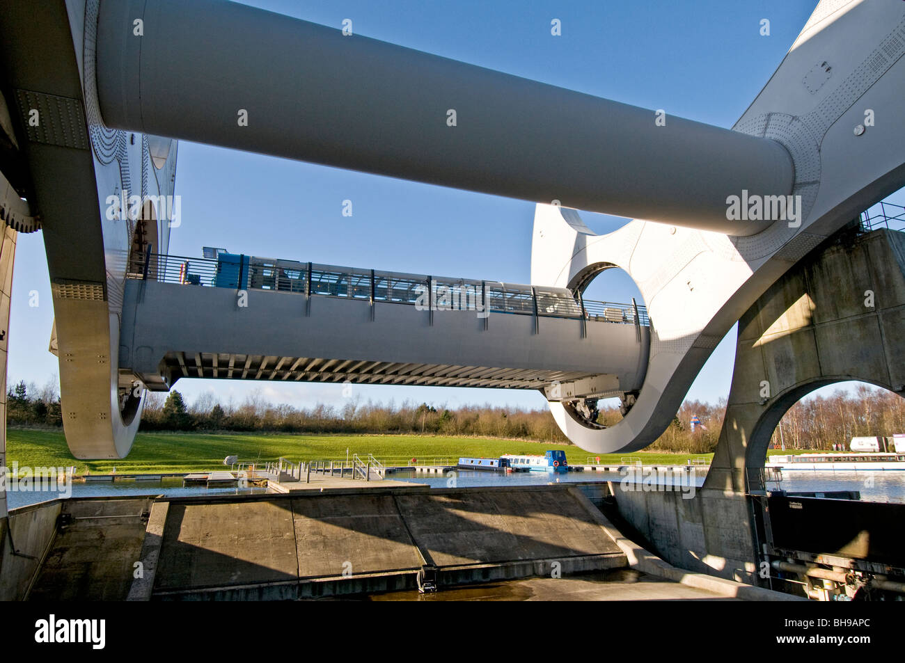 The Falkirk Wheel in rotation lifting boat to 30m elevation linking with upper canal waterway