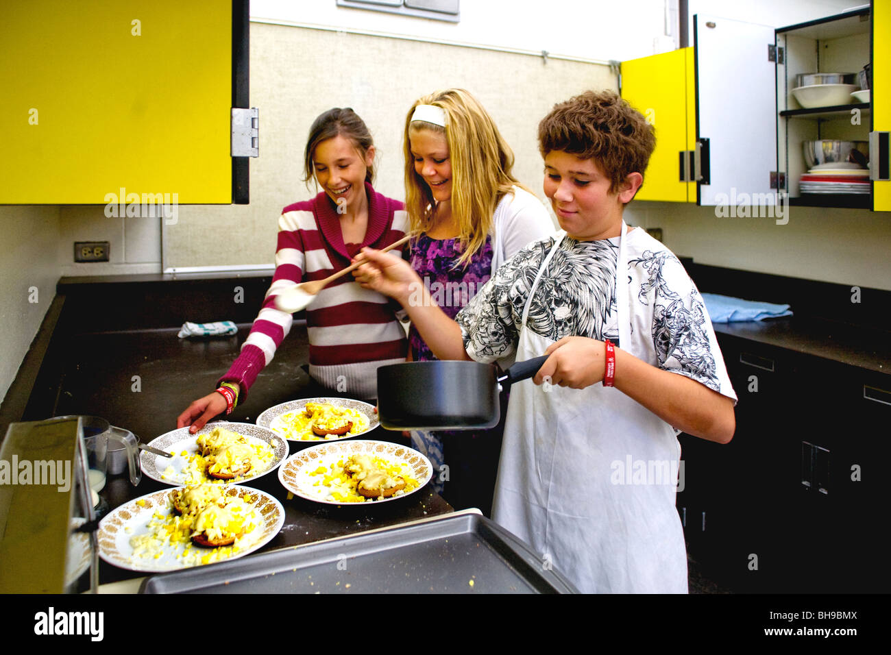 Boys and girls at a Southern California middle school prepare toasted bagels with hardboiled eggs. Stock Photo