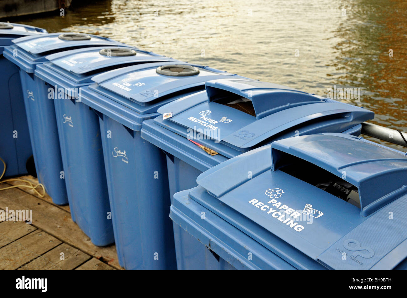 Paper recycling bins next to River Thames Southwark London England UK