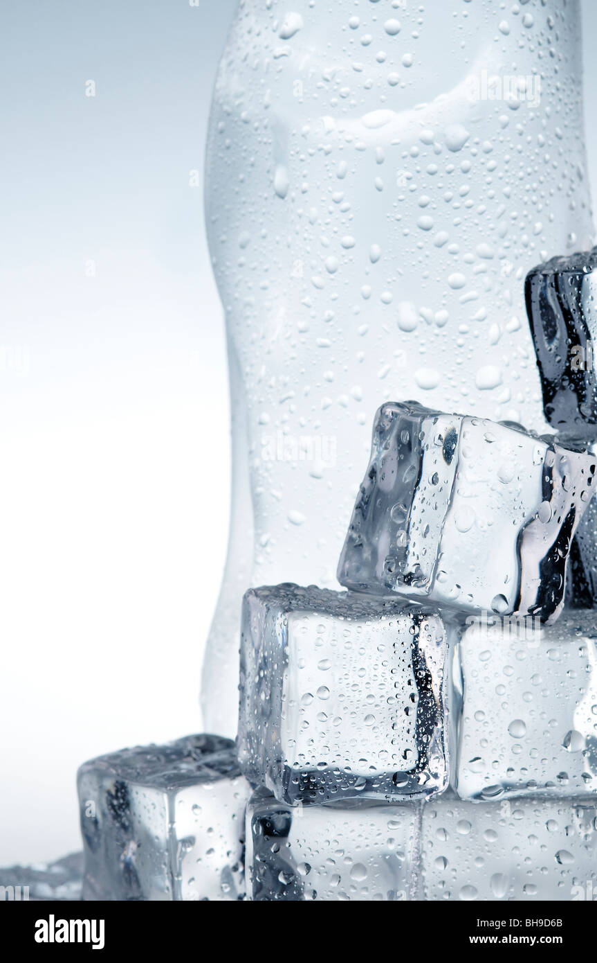 Light blue mineral water bottle and ice cubes Stock Photo