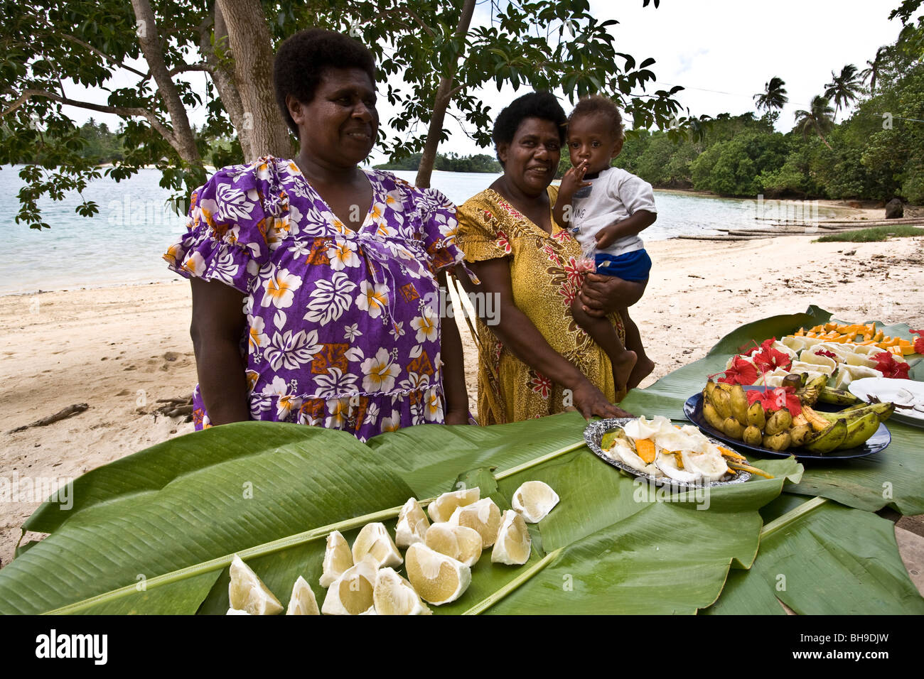 Ladies of Paradise Lagoon prepared fresh fruit for visitors arriving on Espiritu Santo island Vanuatu Stock Photo