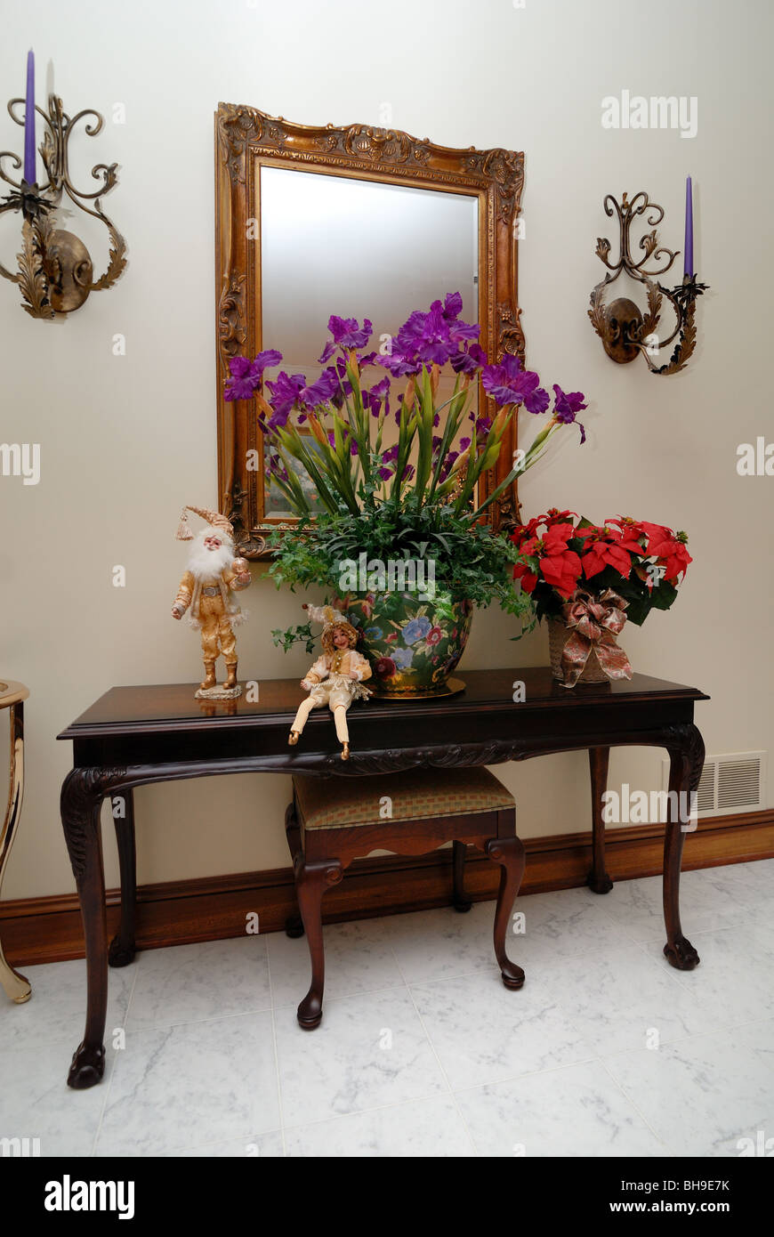 A tasteful hallway table and mirror, decorated for the holiday season. Stock Photo