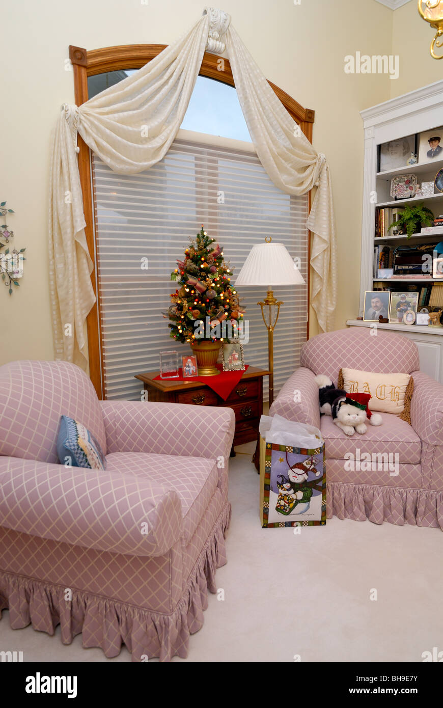 Two comforrtable chairs in the sitting room of a  tasteful home, decorated for the holiday season. Stock Photo