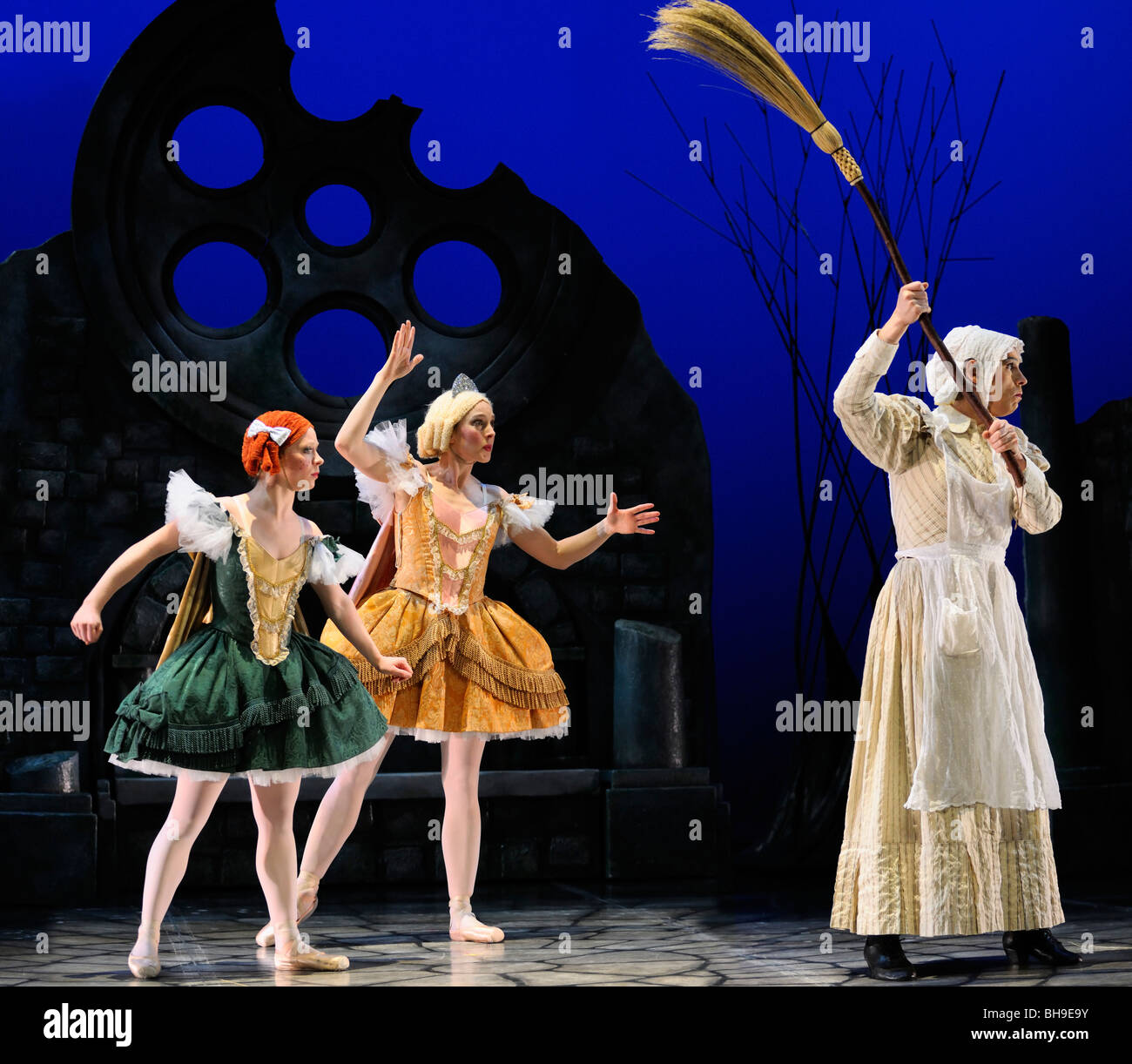 Stepmother with broom and stepsisters frozen by Fairy Godmother in Ballet Jorgen production of Cinderella Stock Photo