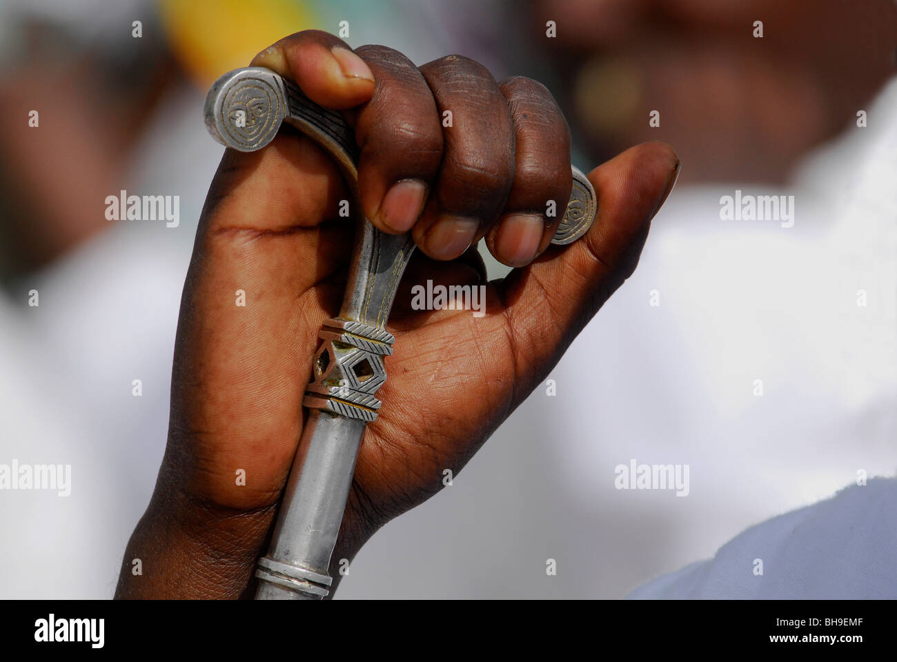 Hand of Ethiopian worshiper gripping prayer staff Stock Photo