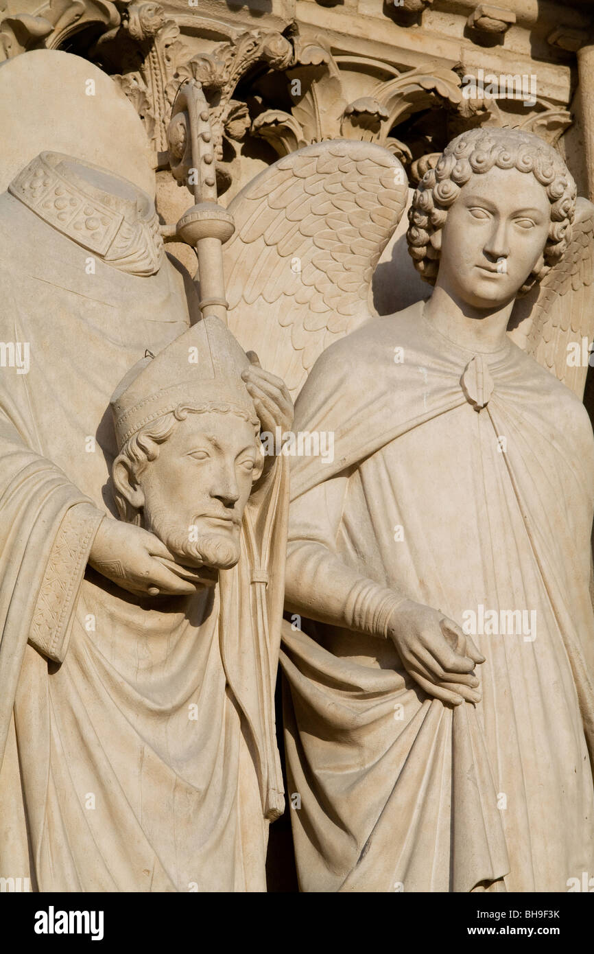 Statue of St Dennis on facade, of Cathedral, Paris, France Stock Photo