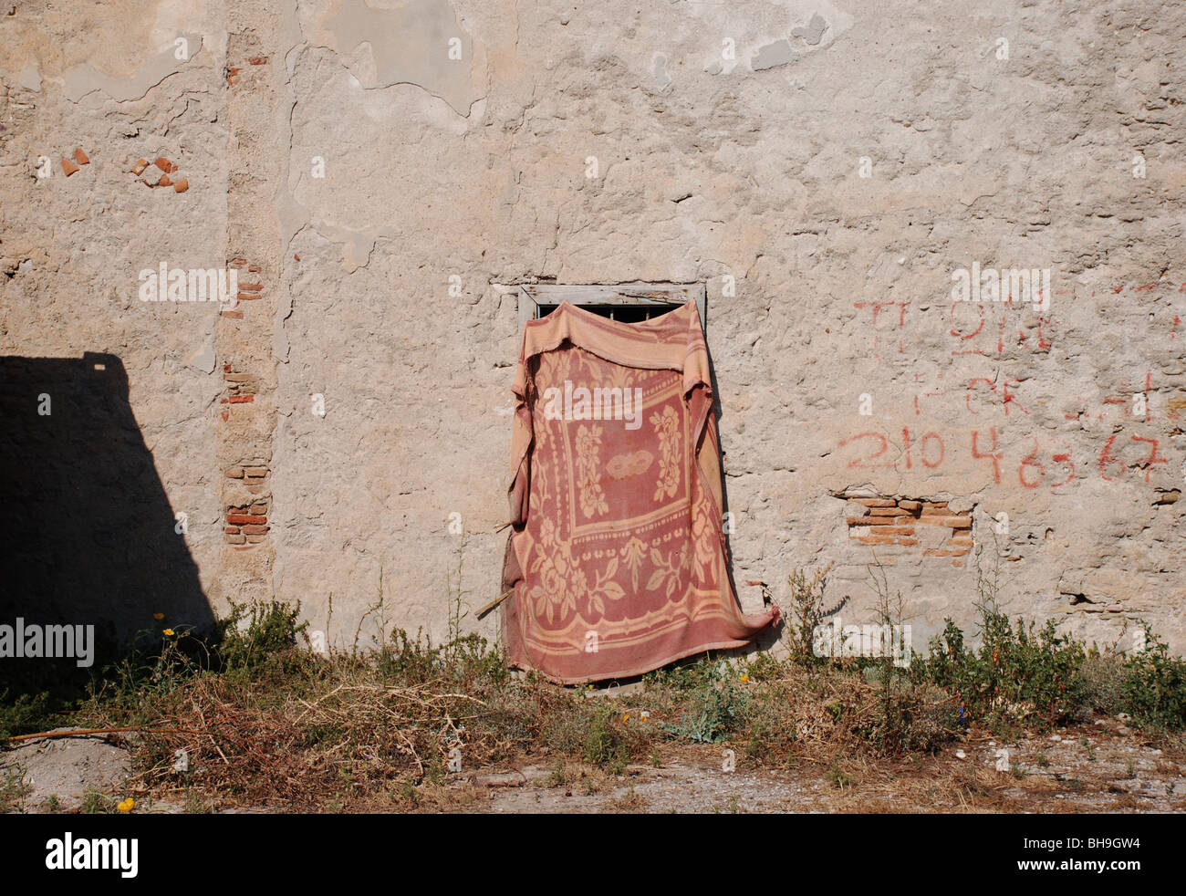 blanket covering a window of a derelict house Stock Photo Alamy