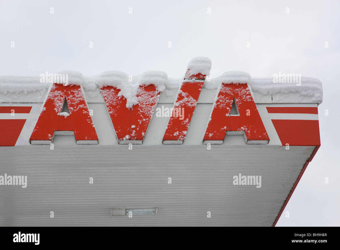Avia corporate logo covered with snow on a filling station Stock Photo