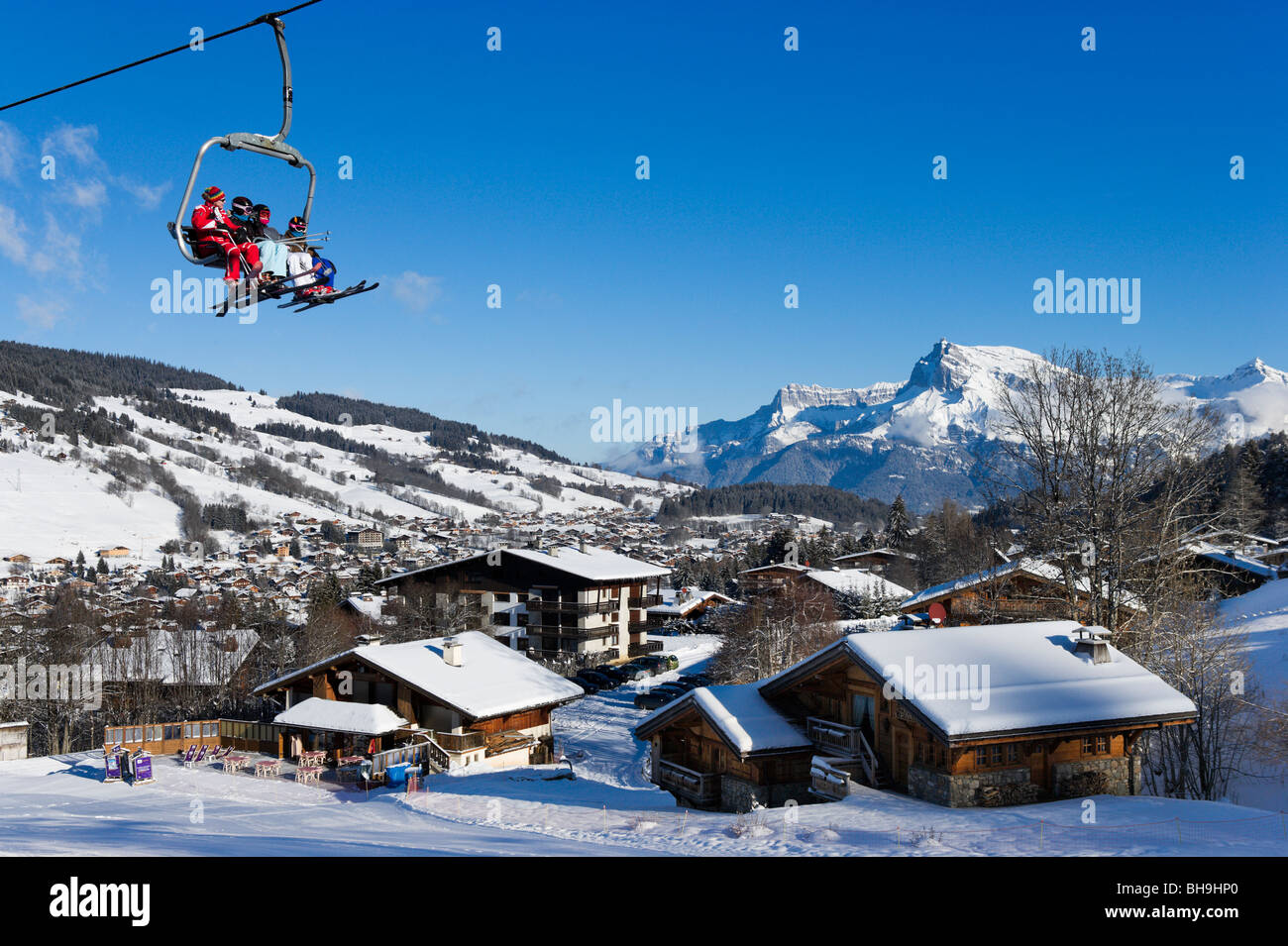 Chairlift and view over the resort from the slopes in the Rochebrune area, Megeve, Haute Savoie, France Stock Photo