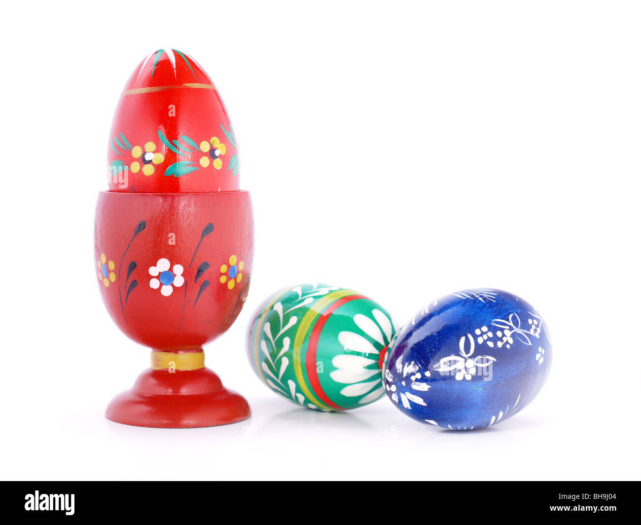 Three easter eggs, one in a cup shot over white background Stock Photo