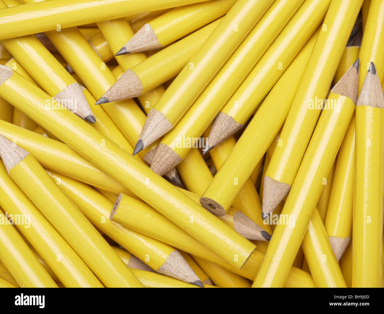 Bunch of yellow wooden pencils shot from above Stock Photo