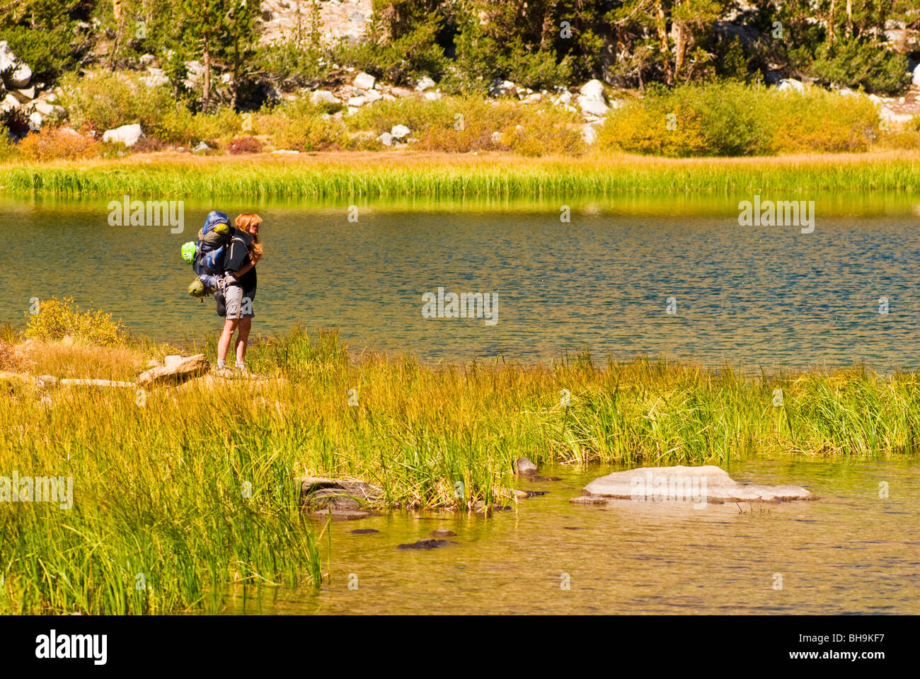 Backpacker on the shore of Heart Lake, John Muir Wilderness, Sierra Nevada Mountains, California Stock Photo