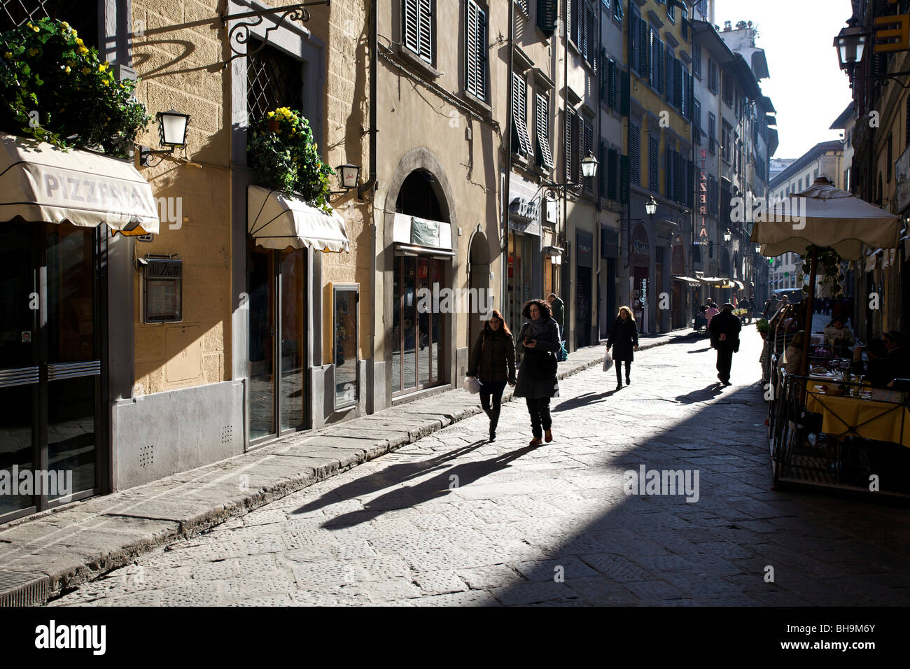 Two women walk down a typical Italian street in Florence Stock Photo ...