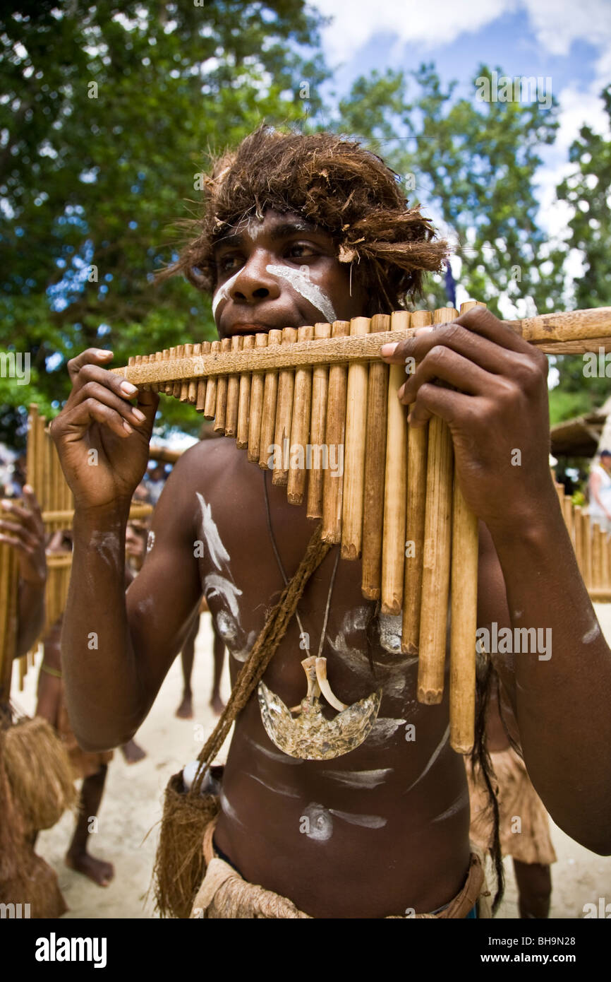 Roderick Bay's pipe band is the pride of Nggela Island A boy plays the traditional bamboo pipe musical instrument Stock Photo