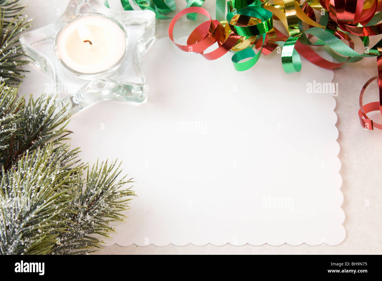 Christmas tea candle with fir branch, red, gold, green ribbon and copy space Stock Photo