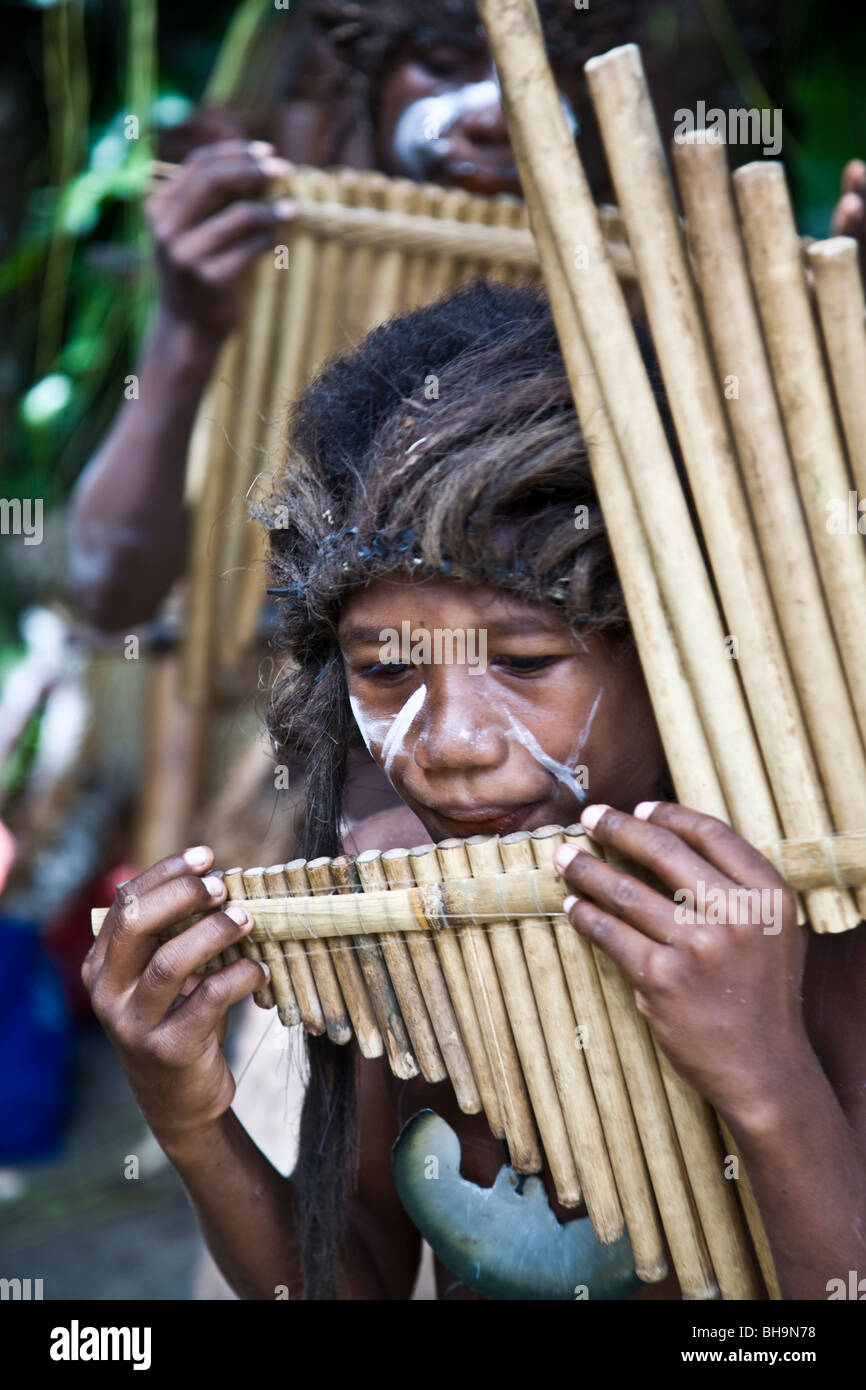 Roderick Bay's pipe band the pride of Nggela Island with boys presenting rousing performances on handmade bamboo mouth harps Stock Photo