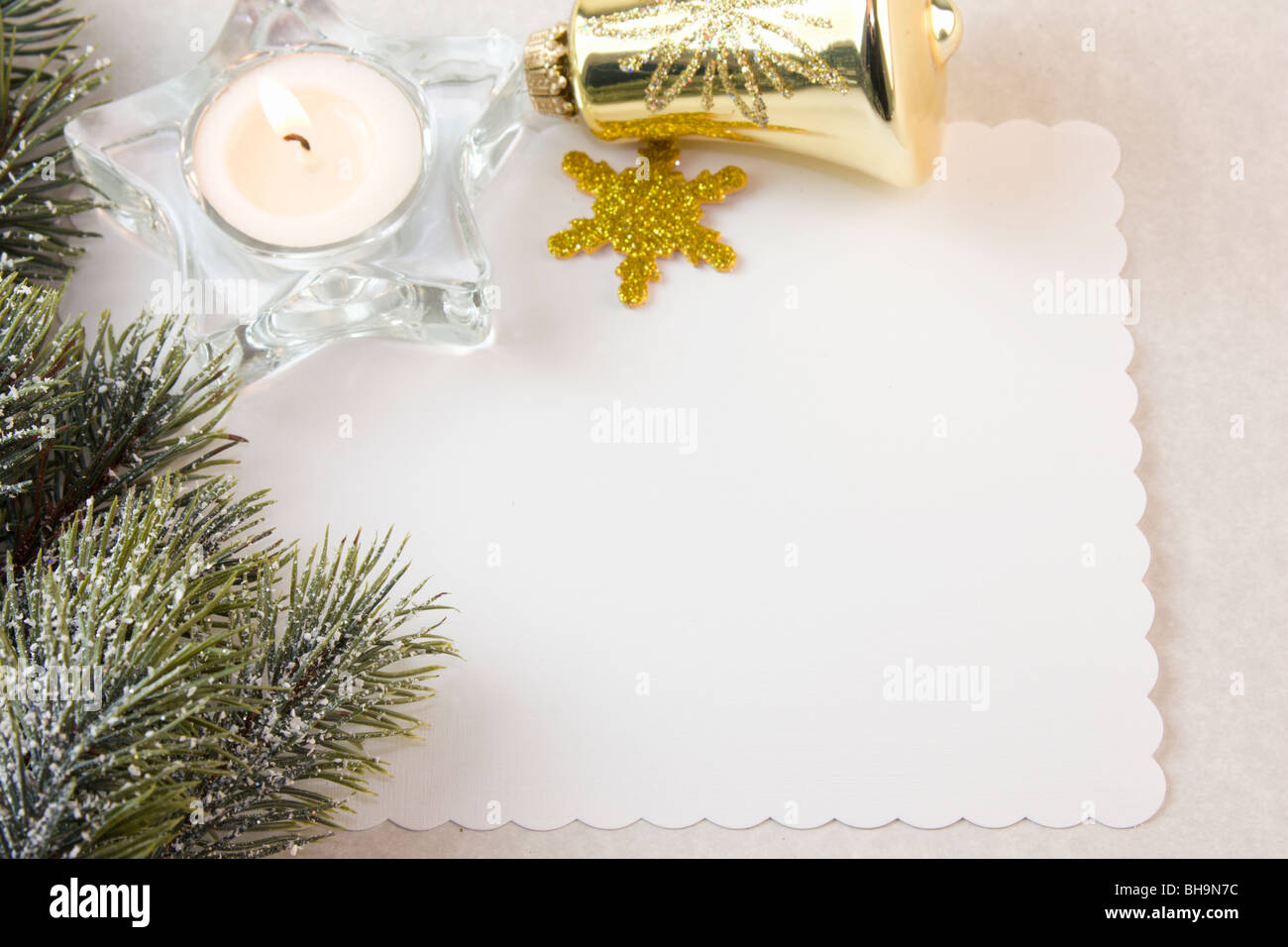 Christmas tea light with gold decorations, fir branch, and copy space Stock Photo