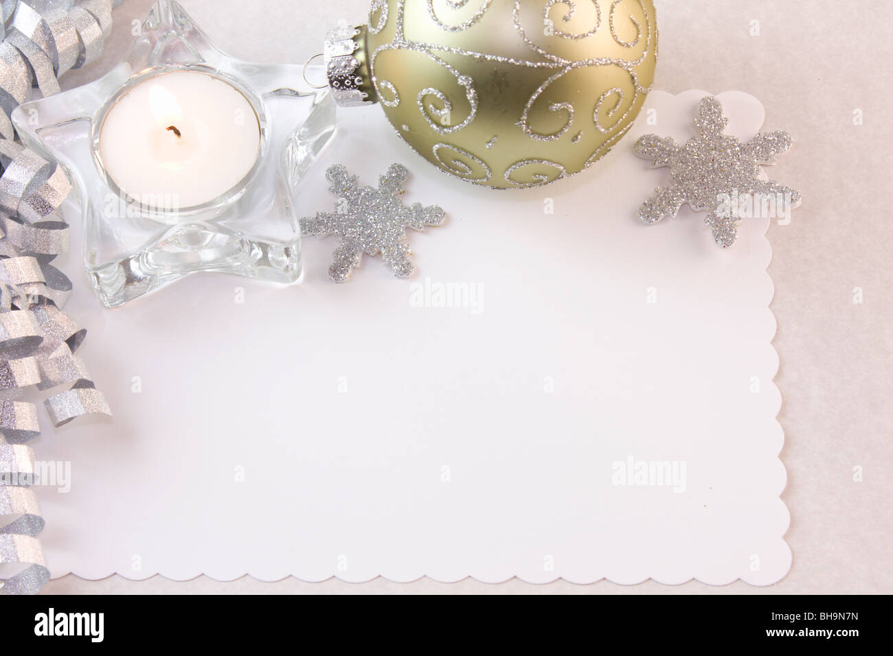 blank Christmas card with tea light candle and silver decorations Stock Photo