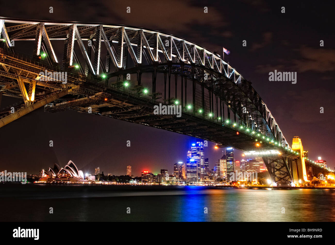 SYDNEY, Australia - SYDNEY, Australia - Night shot of Sydney Harbour Bridge and skyline of Sydney city looking back towards Dawes Point and taken from Milsons Point. The Sydney Opera House is at extreme left. Dawes Point is at right Stock Photo