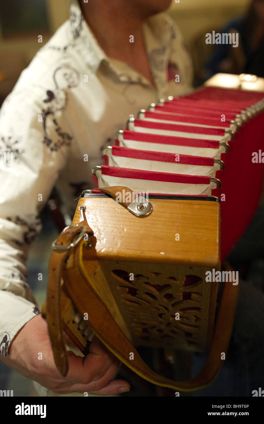 Playing a melodeon in the Scottish folk music session in a pub Stock Photo