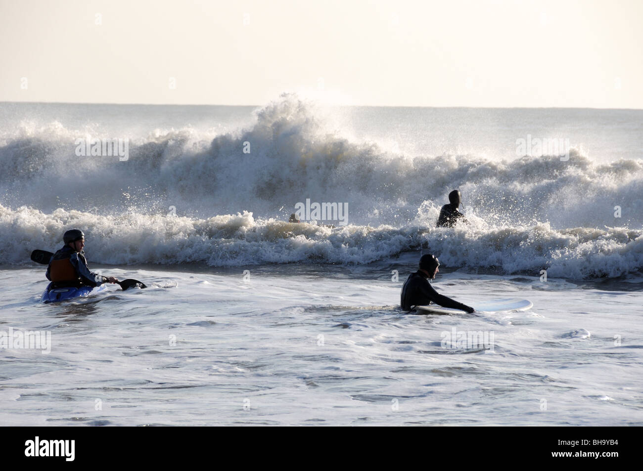 Surfers and Kayaker Stock Photo