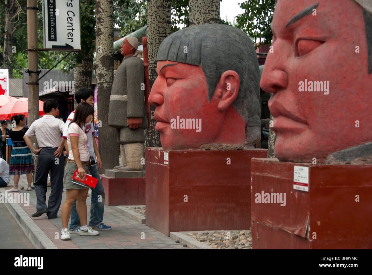 Beijing, CHINA- Chinese Contemporary Art on Display in 798 Art Factory, Teen Couple Visiting Modern Art Sculpture Outside, art outdoor Stock Photo