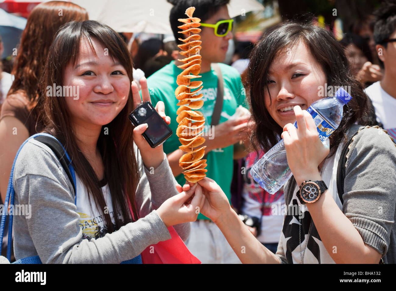 HONG KONG - MAY 2: Two Chinese girls in Cheung Chau celebrating the bun festival on May 2, 2009. Stock Photo