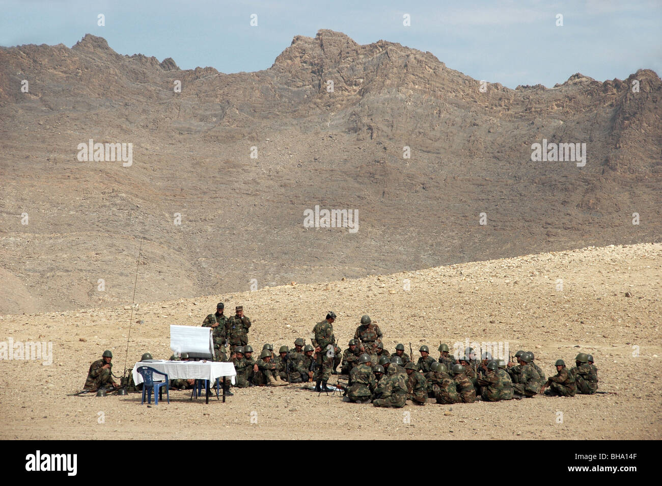 A group of Afghan National Army (ANA) recruits receiving basic training in an outdoor classroom setting in the mountains near Kabul, Afghanistan. Stock Photo