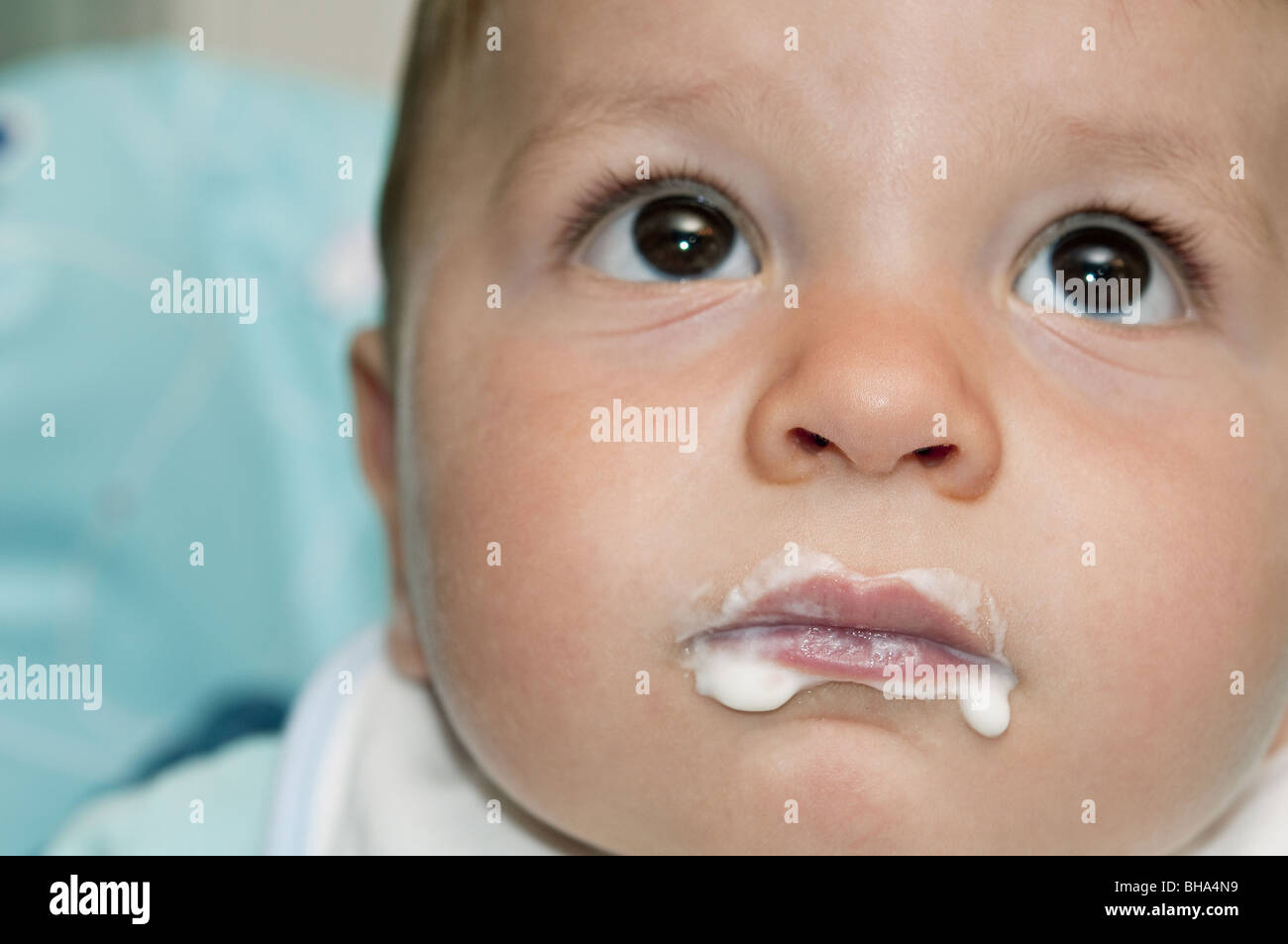 Closeup of baby boy's face with food around his mouth Stock Photo