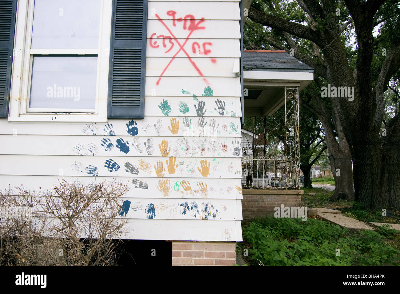 The external wall of a house has hand prints in various colors. 9 months after Hurricane Katrina, New Orleans, LA. Stock Photo