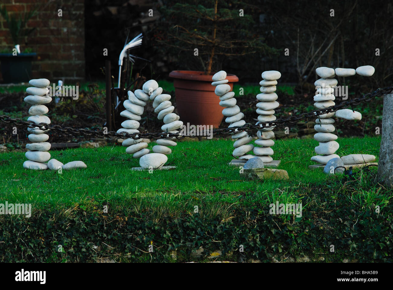 A 'love' pebble sculpture on a river bank Stock Photo