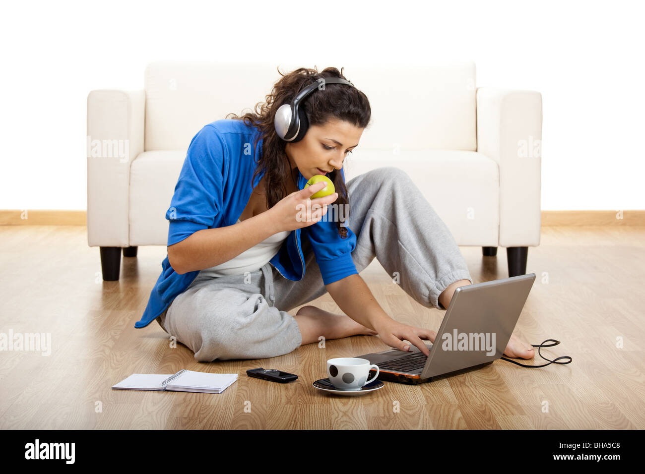 Girl sitting on floor and working with a laptop Stock Photo - Alamy