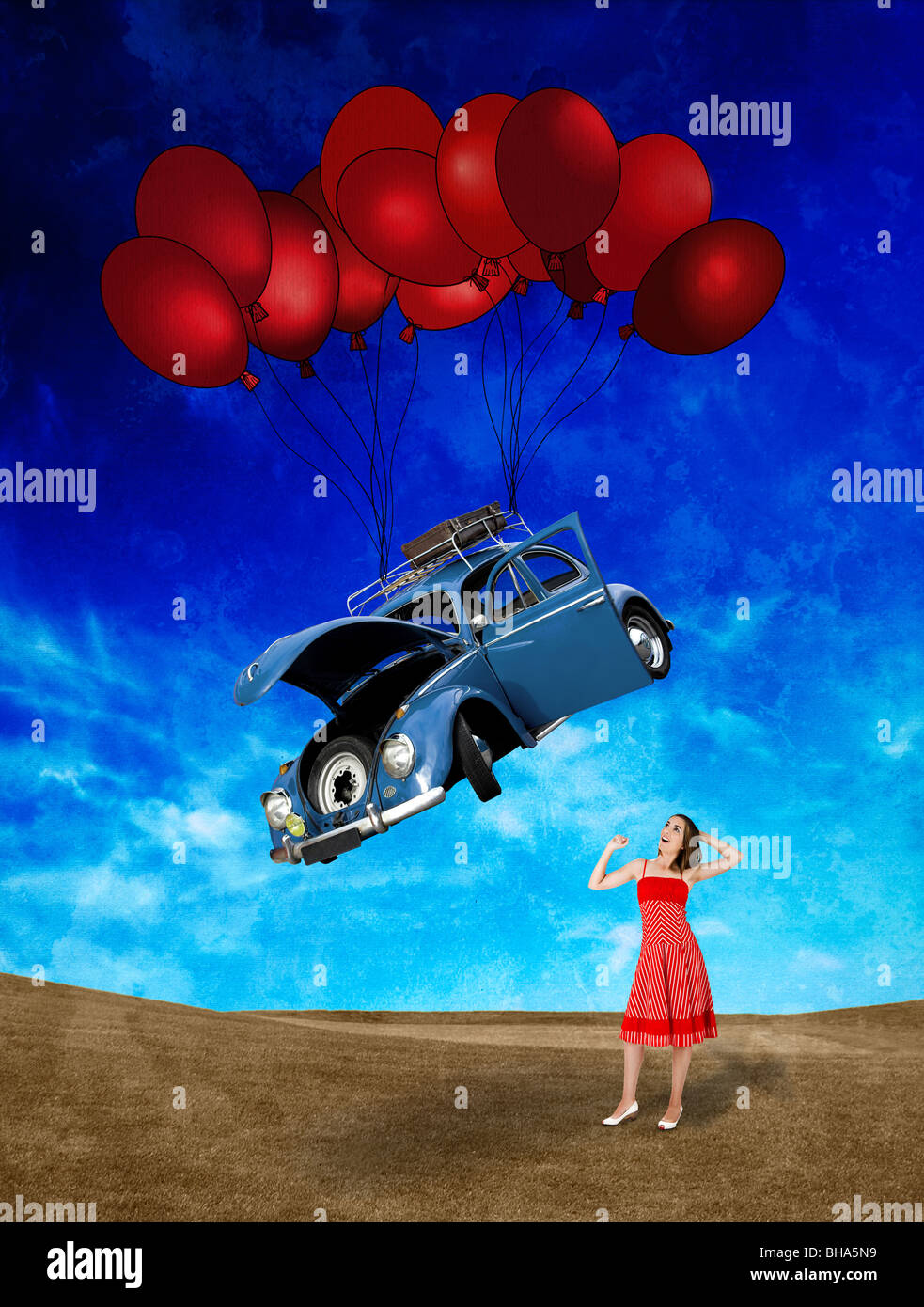 Woman witing for a beetle car falling from the sky with balloons Stock Photo