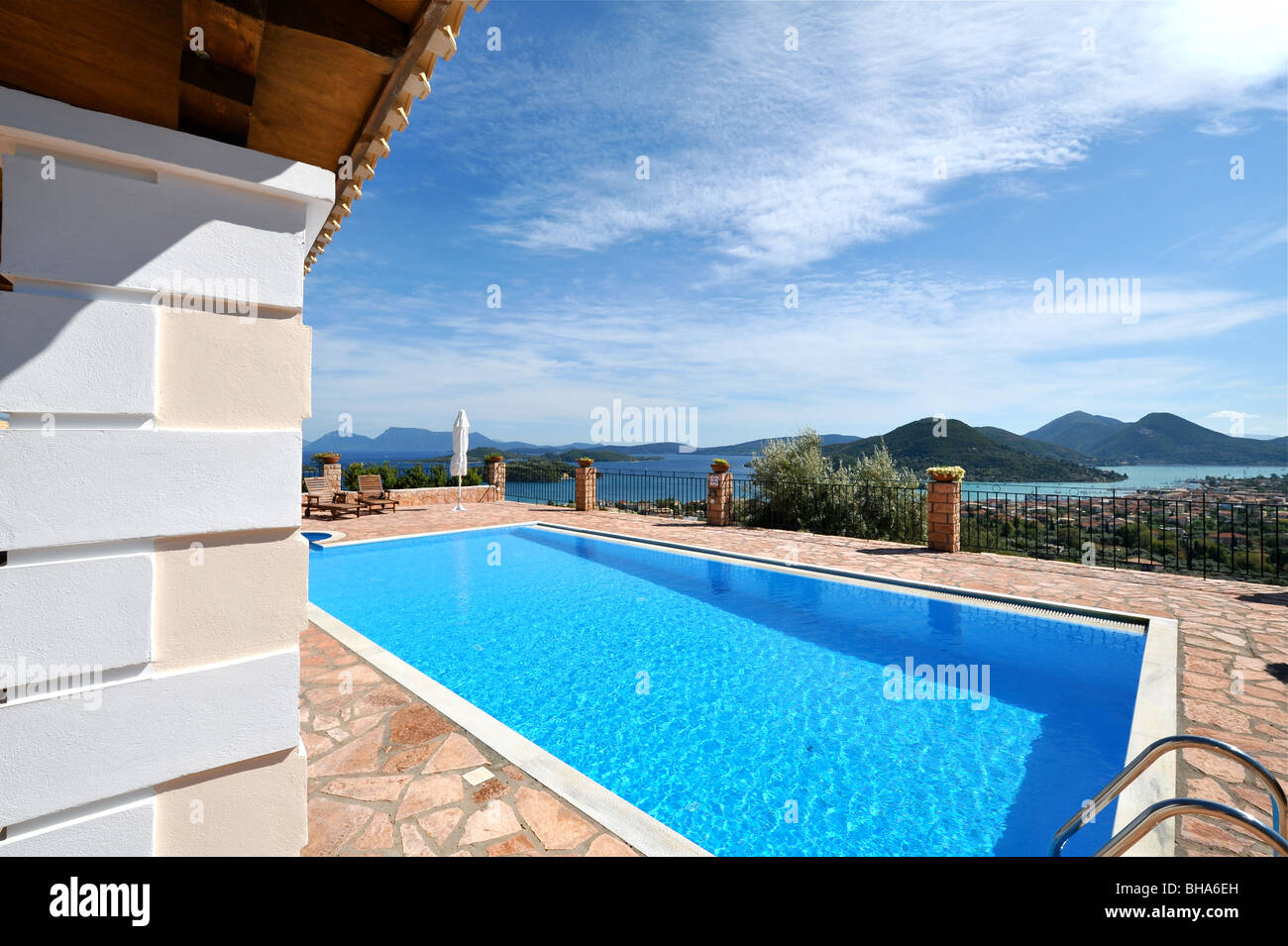 Holiday vacation villa with an excellent view from the swimming pool deck towards Meganissi Island, Lefkas, Greece. Stock Photo