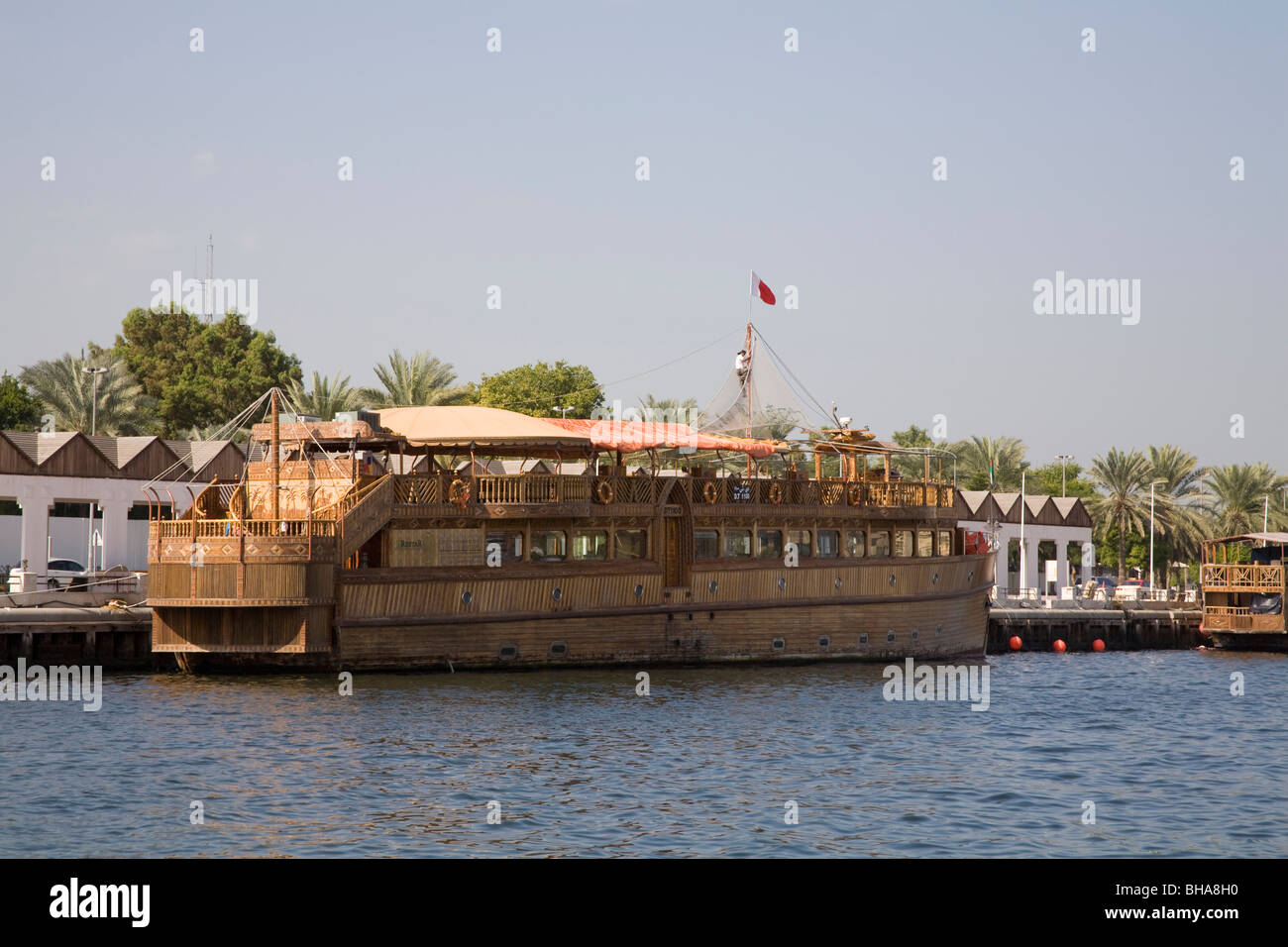 Dubai United Arab Emirates Arab Dhow housing a floating restaurant moored at the side of Dubai creek Stock Photo