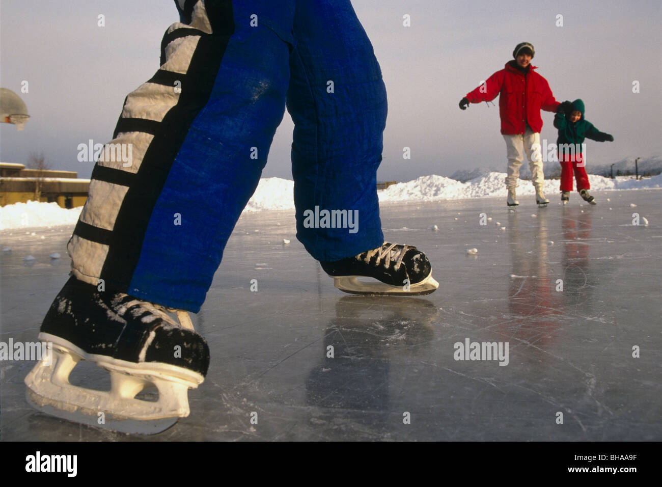 Closeup of boy's legs and ice skates Anchorage AK Southcentral Family