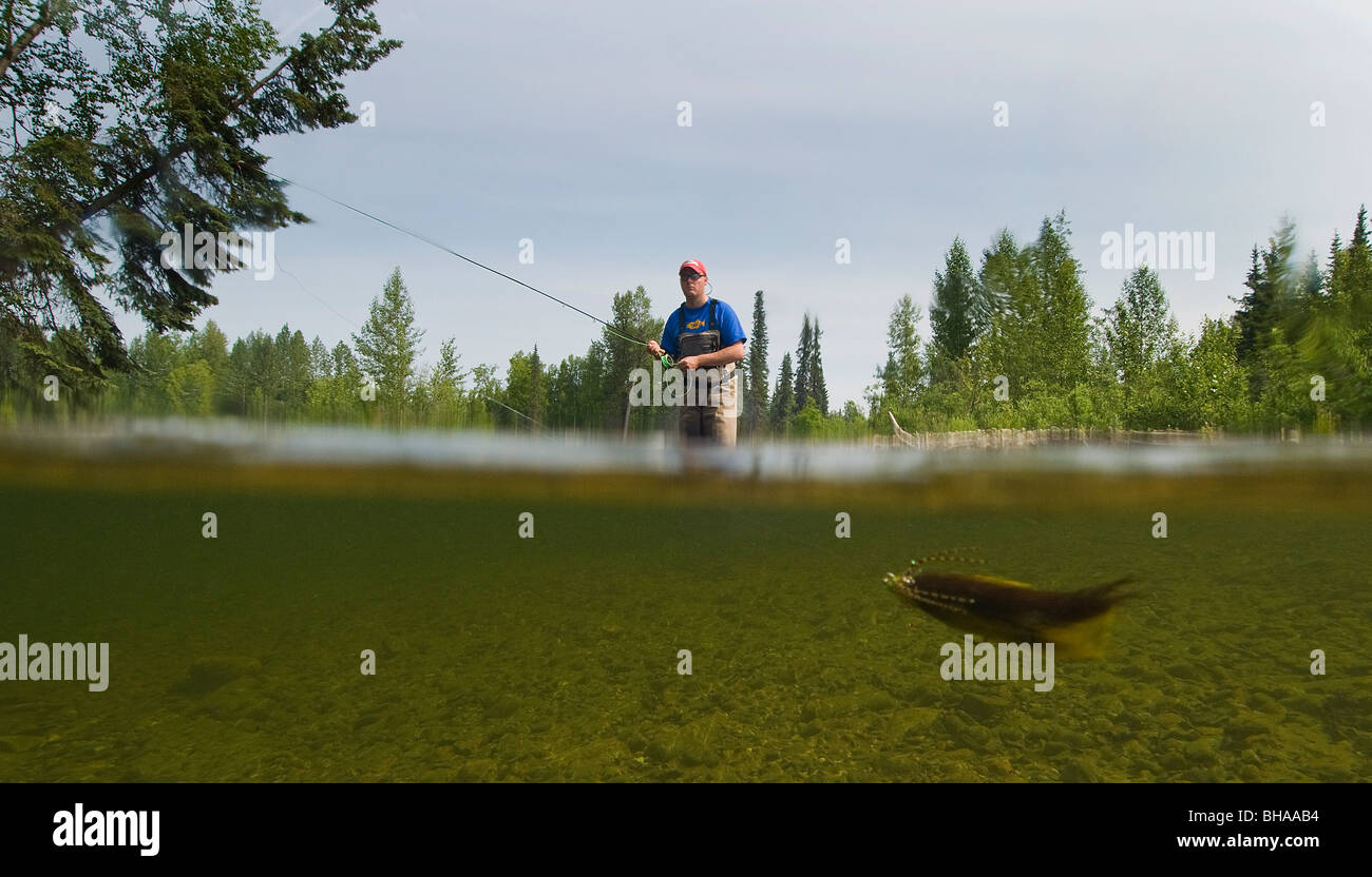 Underwater perspective of a fly fisherman fishing for rainbow trout in