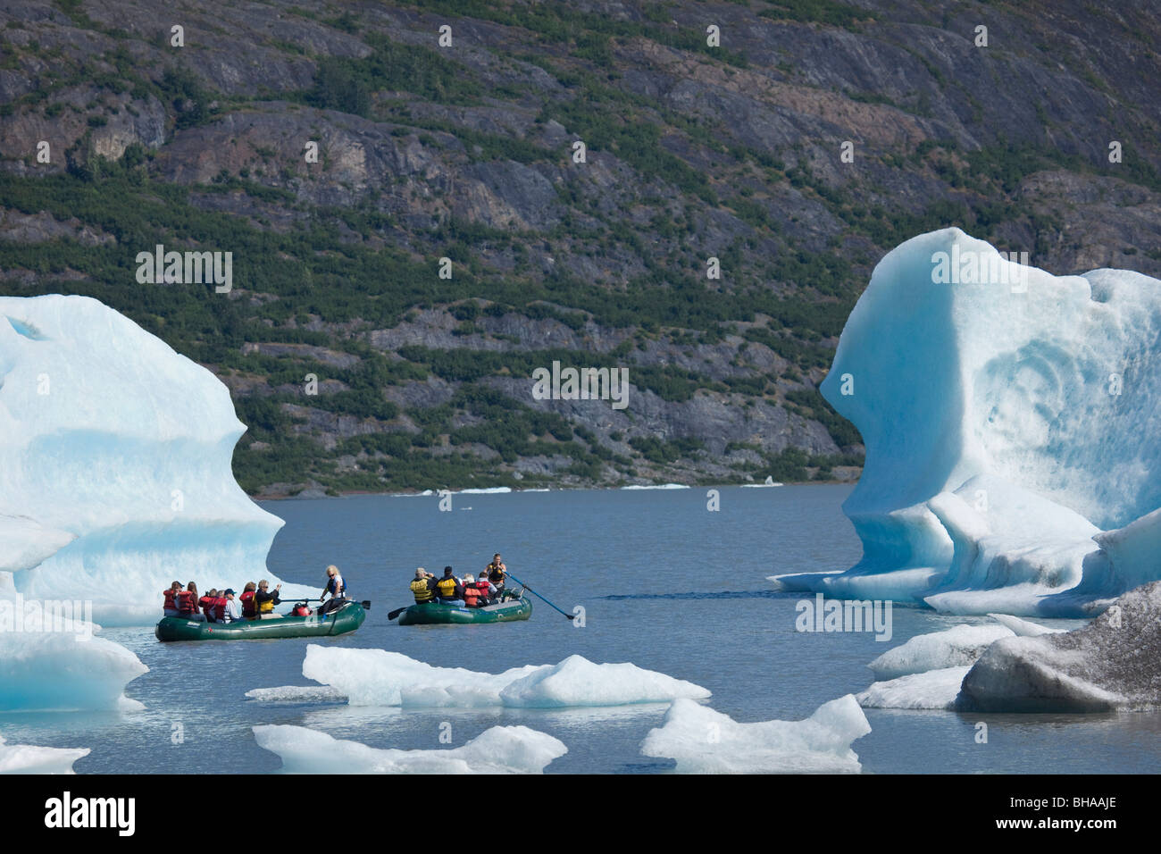 Rafters float among large icebergs calved from the Spencer Glacier in
