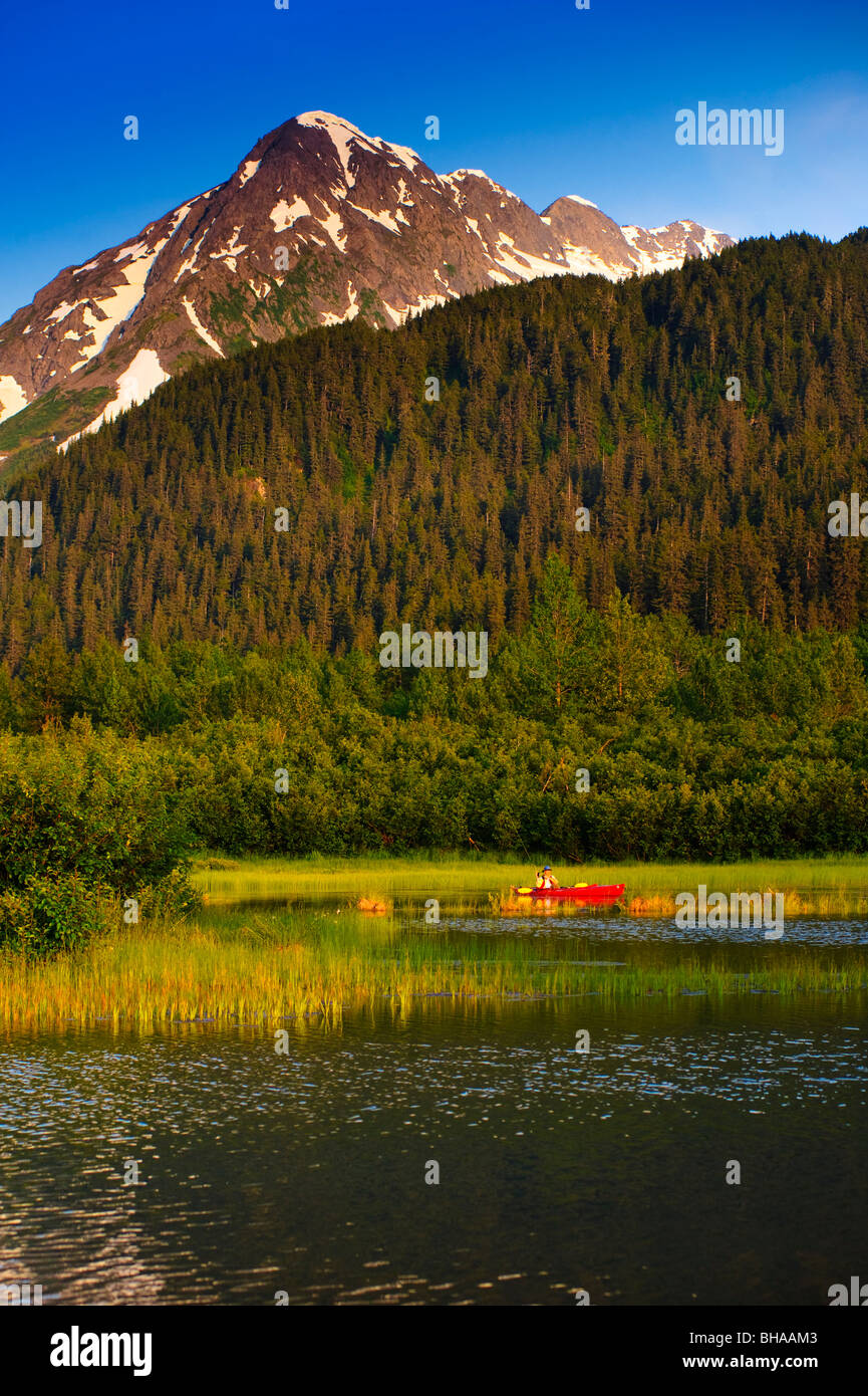 Man in a kayak paddling in a lake in Portage Valley, Southcentral, Alaska, Summer Stock Photo